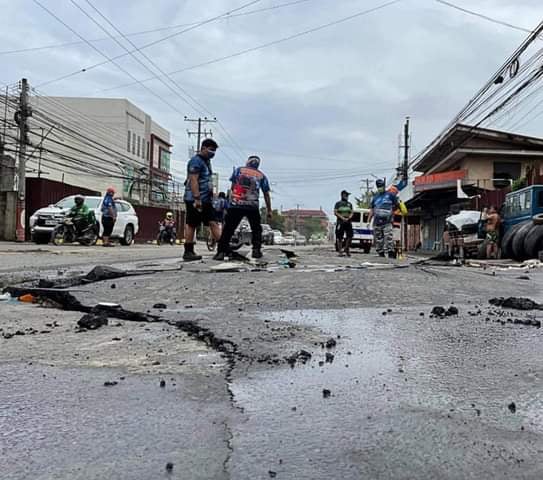 MOTORISTS TOLD TO DRIVE CAREFULLY IN THIS AREA. Mandaue City Emergency disaster personnel check the damaged road in Lopez Jaena Street in Barangay Subangdaku, Mandaue City. | MDRRMO photo