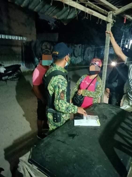 CONSOLACION MOTOR STOP NETS 18 TRAFFIC VIOLATORS. In photo is A motorcycle rider-traffic violator is issued a citation ticket by the Consolacion policemen at a "motor stop" in Barangay Nangka at past midnight or early morning of Saturday, June 26. |Photo courtesy of Consolacion police