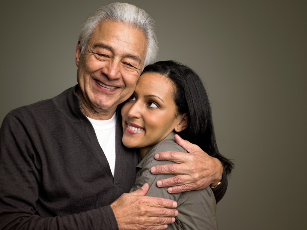 daddy's girl stock photo. Old man and a young woman in a hug.
