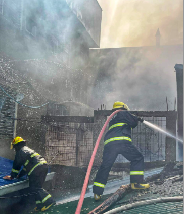 Firefighters train their hose at the roof of one of the affected establishments during the Capitol Site, Cebu City fire this morning, June 18. | Photo courtesy of the Cebu City Fire Department