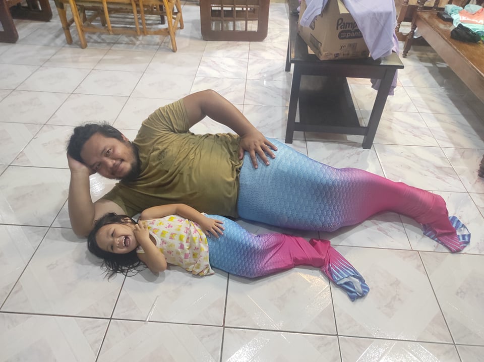 Tatay and her little girl tries on the merman costume a day before the photo shoot.