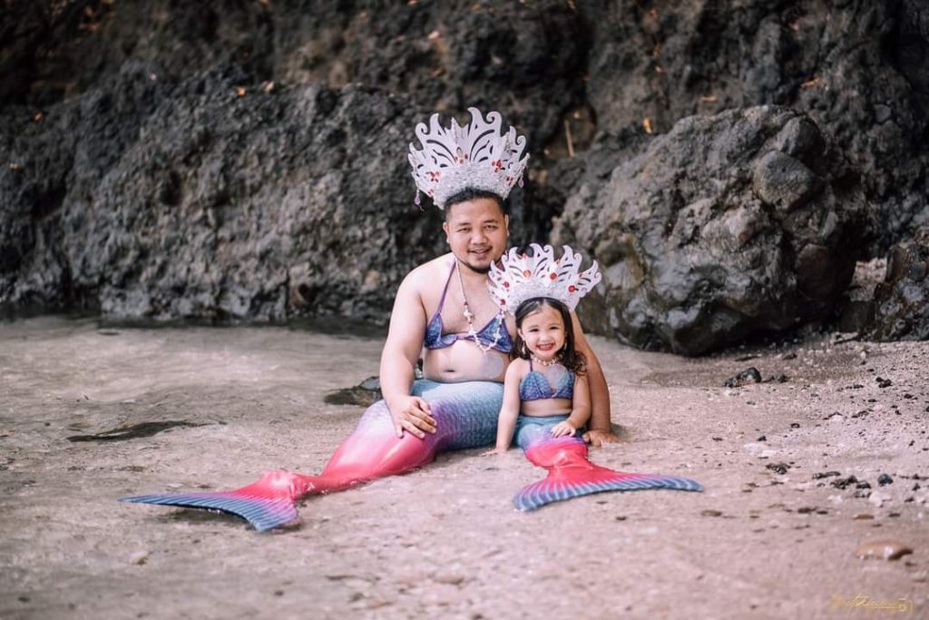 Tatay wears a merman costume for her little girl's photo shoot.