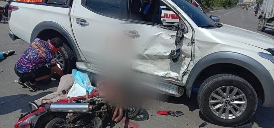 Two dead after motorcycle crashes into pickup truck in Mandaue City today. Photo shows a motorcycle, the motorcycle driver lying on the road at the side of a damaged pickup truck.