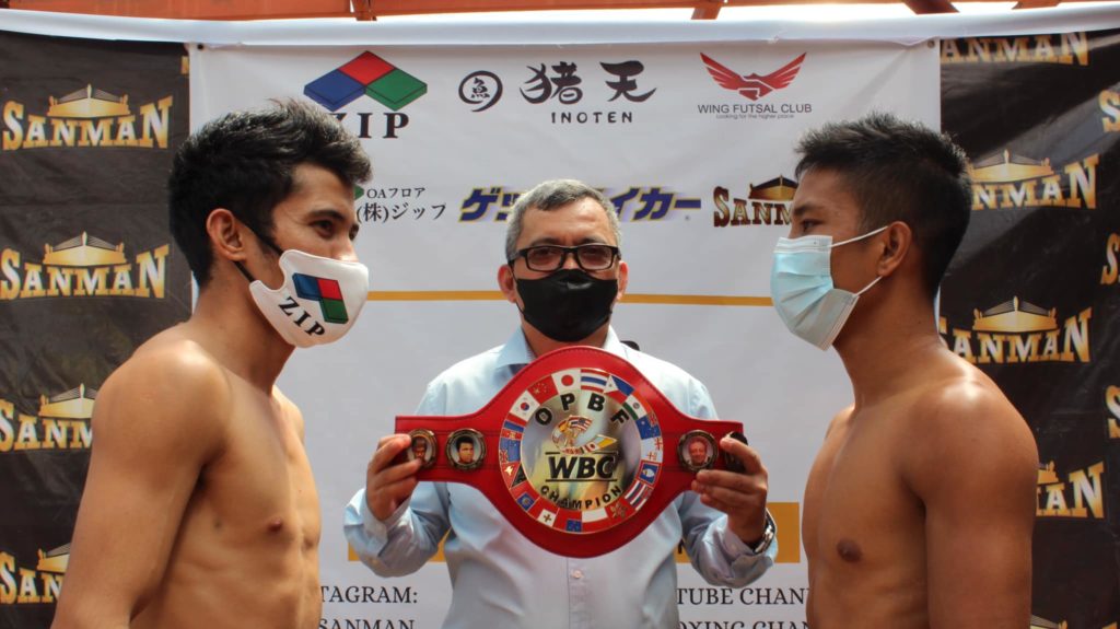 JERUSALEM VS. LANDERO: Melvin Jerusalem (left) and Toto Landero (right) engaged in a staredown after passing the weigh-in for their OPBF title bout tomorrow. They were joined by OPBF supervisor Arnie Najera (middle) who is seen holding the belt. | Photo from Zip Sanman Facebook page