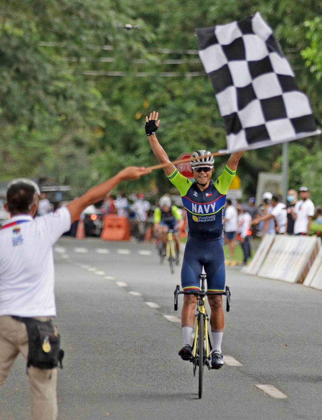 PHILIPPINE NAVY TEAM DOMINATES.  In photo is Ronald Oranza of the Philippine Navy-Standard Insurance Cycling Team, who raises his hands at the finish line after topping the men's road race in last Sunday's PhilCycling National Trials in Clark Freeport Zone in Pampanga. | Contributed Photo