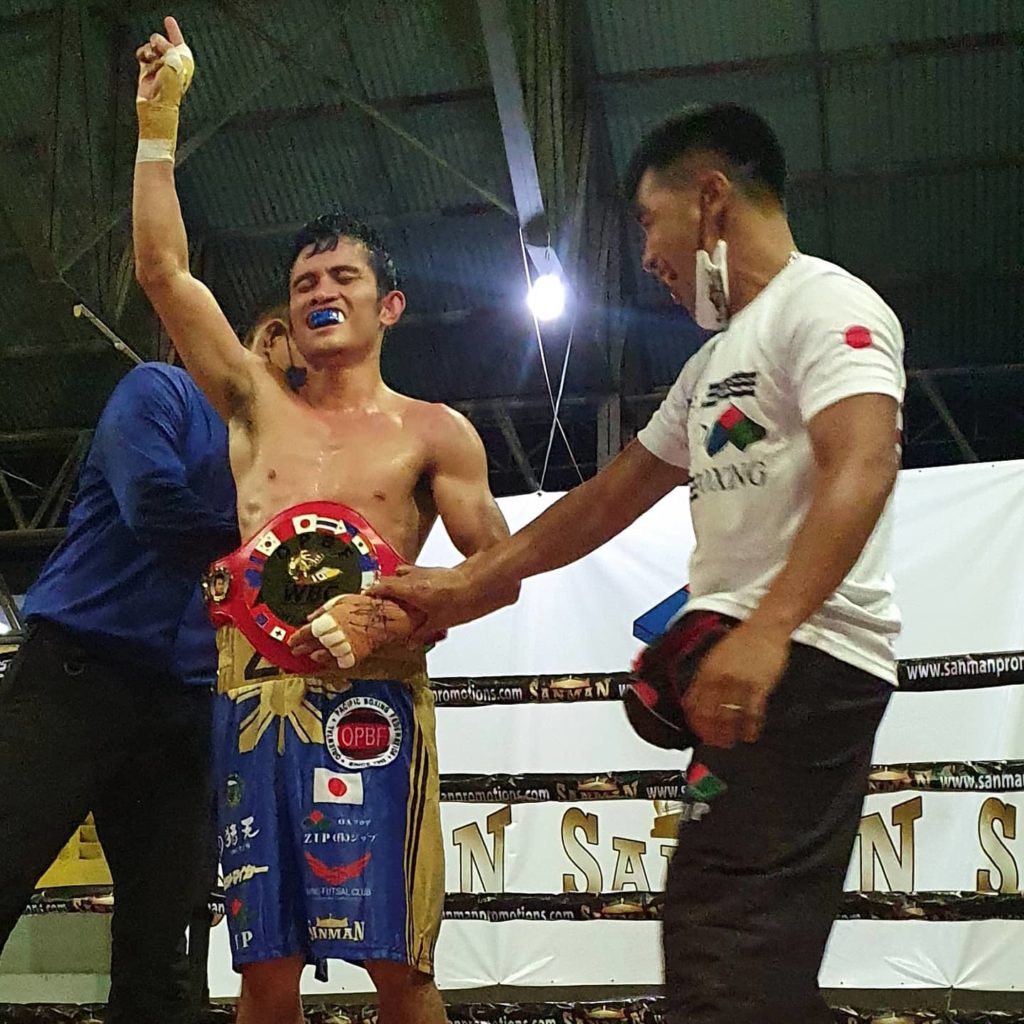 Melvin Jerusalem raises his hand as the OPBF minimumweight belt is strapped around his waist after winning over Toto Landero last Friday evening at the Tabunok sports complex. | Photo from Zip Sanman promotions.