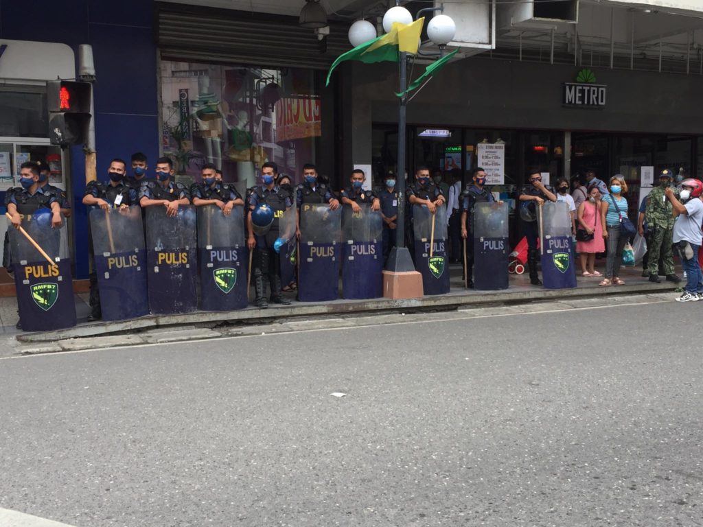 Cebu City Policemen in riot gear line up a portion of the street as they monitor at least 100 protesters this morning. | Pegeen