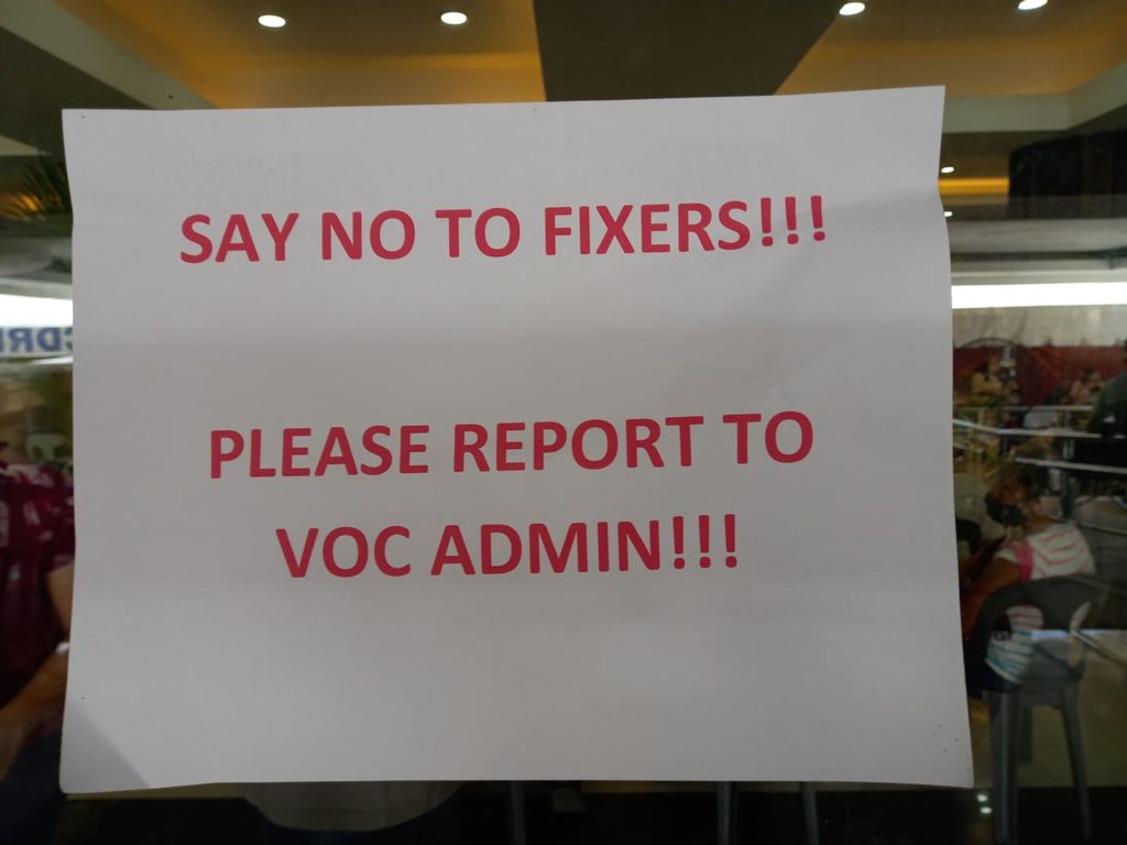 MANDAUE FOCUSES ON FIXERS. A sign warning "vaccination fixers" at one of the vaccination sites in Mandaue City is posted on its entrance. | Mary Rose Sagarino