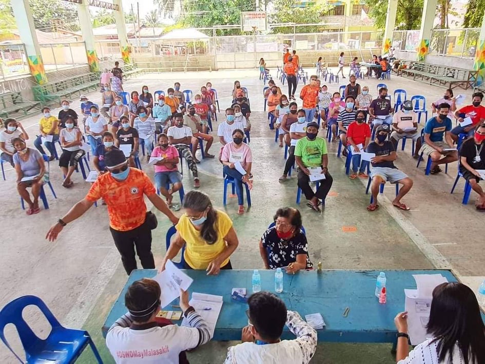 Oponganons receive AICS program payout. In photo are among the 2,454 beneficiaries of the Individuals in Crisis Situation program of the Department of Social Welfare and Development in Lapu-Lapu City, who have received their P1,500 cash assistance. | Contributed photo