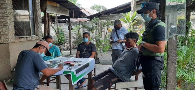 Buy-busts in Cebu, Negros nets 4 high value individuals. In photo are the three arrested drug suspects with PDEA-7 agents doing an inventory of the confiscated illegal drugs from the suspects. | Photo by PDEA-7