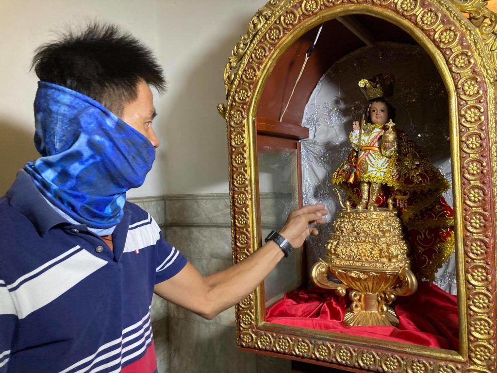 POLICE TRYING TO FIND OUT IF MAN IS MENTALLY CHALLENGED OR NOT. One of the maintenance personnel of the National Shrine of St. Joseph shows the damaged case of the image of the Sto. Niño whose glass was shattered after a man threw a stone on it during a morning Mass on Monday, Oct. 11. | Contributed photo
