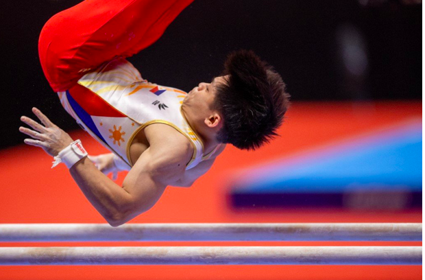 The Philippines’ Carlos Edriel Yulo competes in the parallel bars event at the men’s apparatus finals during the Artistic Gymnastics World Championships at the Kitakyushu City Gymnasium in Kitakyushu, Fukuoka prefecture on October 24, 2021. (Photo by Philip FONG / AFP)