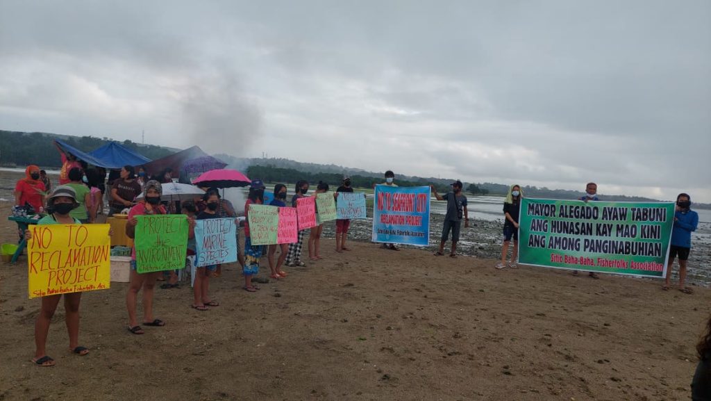 Some 100 fisherfolk hold a protest rally along the shoreline of Barangay Tayud in Consolacion town opposing the planned reclamation project in the area. | Futch Anthony Inso