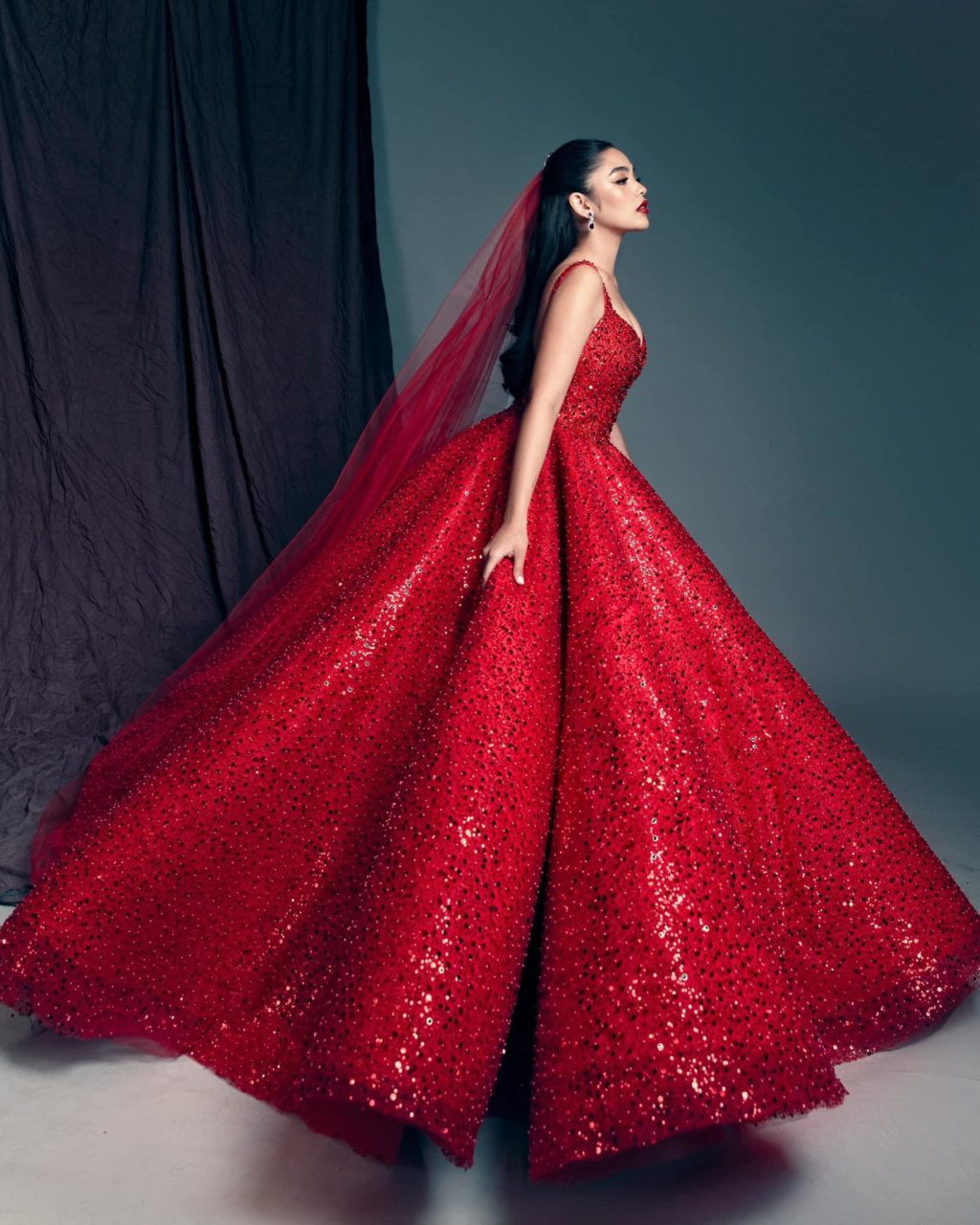 Andrea Brillantes in a red bridal gown.
