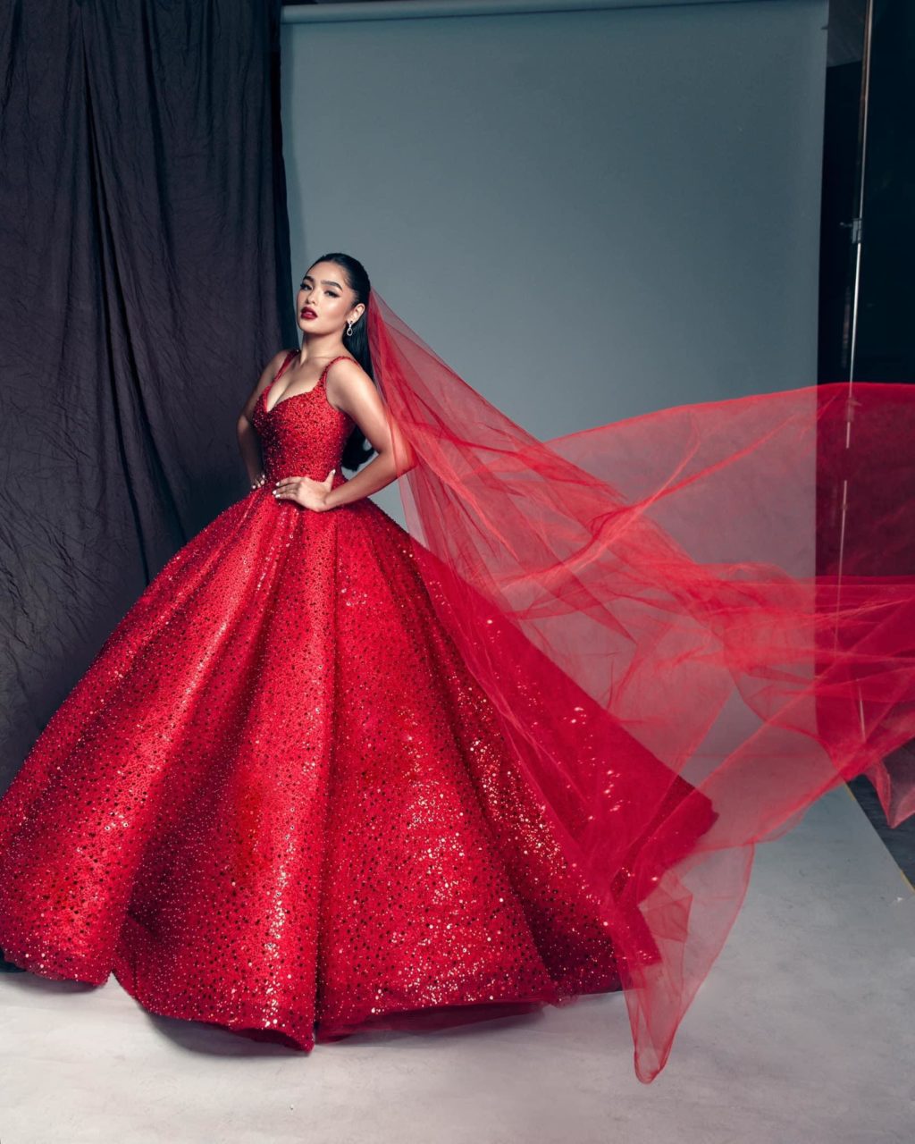 Andrea Brillantes in a red bridal gown.