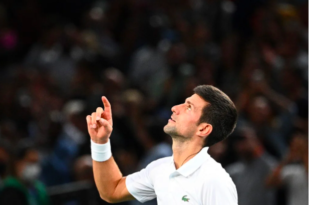 Winner Serbia’s Novak Djokovic celebrates after winning against Russia’s Daniil Medvedev at the end of their their men’s single final tennis match on the last day of the ATP Paris Masters at The AccorHotels Arena in Paris on November 7, 2021. (Photo by Christophe ARCHAMBAULT / AFP)