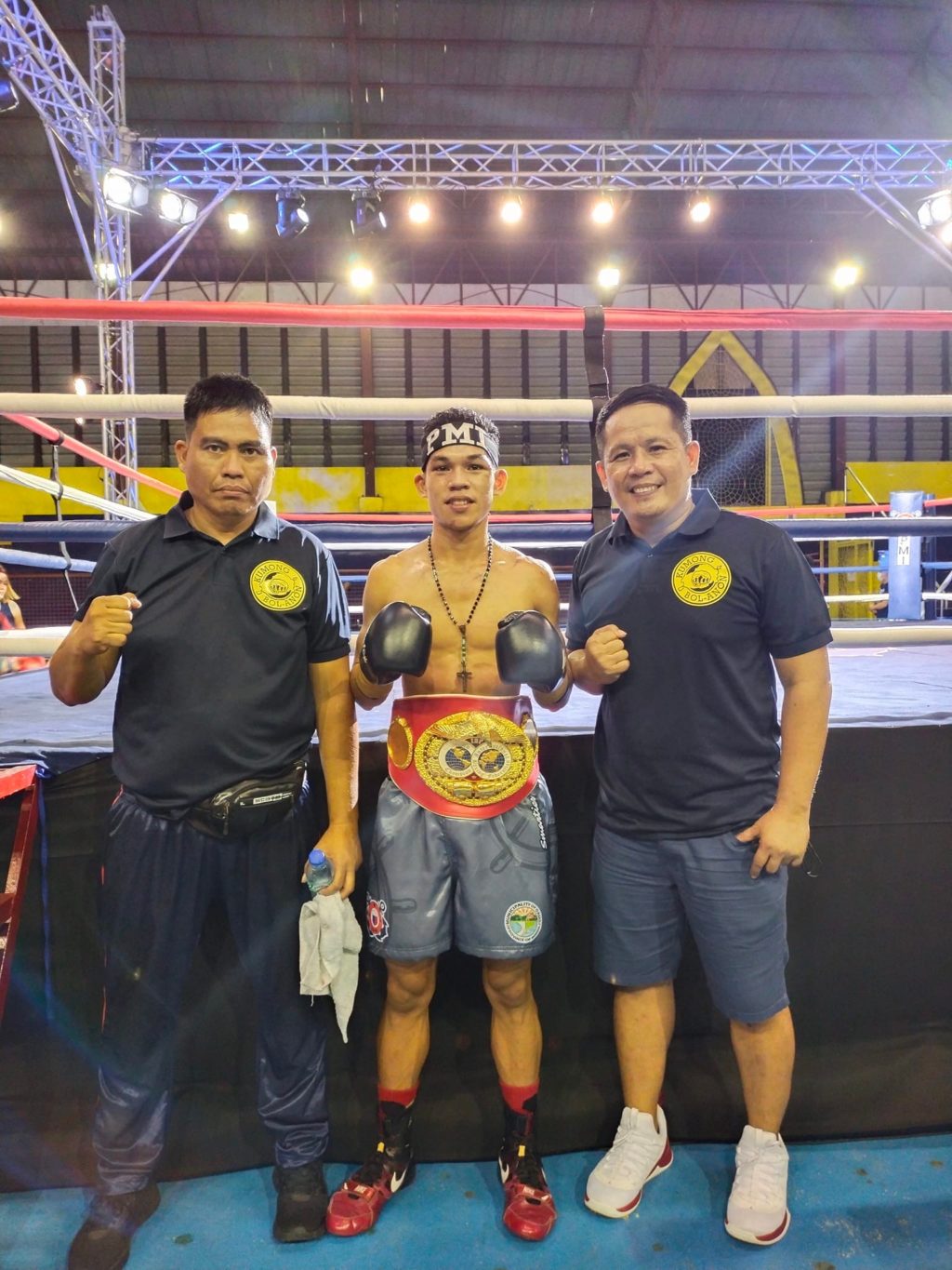 SUGANOB WINS. The newly crowned IBF youth light flyweight champion Regie Suganob is flanked by his trainers, Edsel Burlas (left) and Glenn Sasing (right) of PMI Bohol Boxing Stable. | Photo from Sasing's Facebook Page.