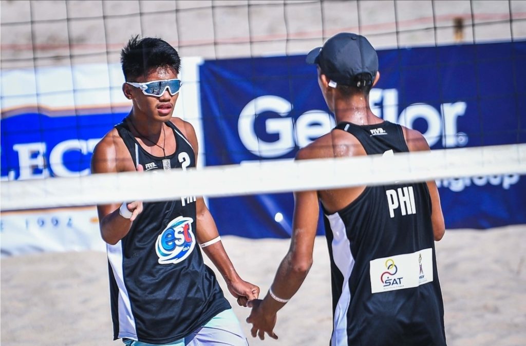 PH TANDEM SNARES 1ST WORLD CHAMPIONSHIP LEVEL BEACH VOLLEYBALL WIN. Alexander Iraya (left) tries to give Jayrack Dela Noche (facing back) a high-five during their victory against Estonia in the FIVB Beach Volleyball U19 World Championships in Phuket, Thailand. | Photo from PNVF