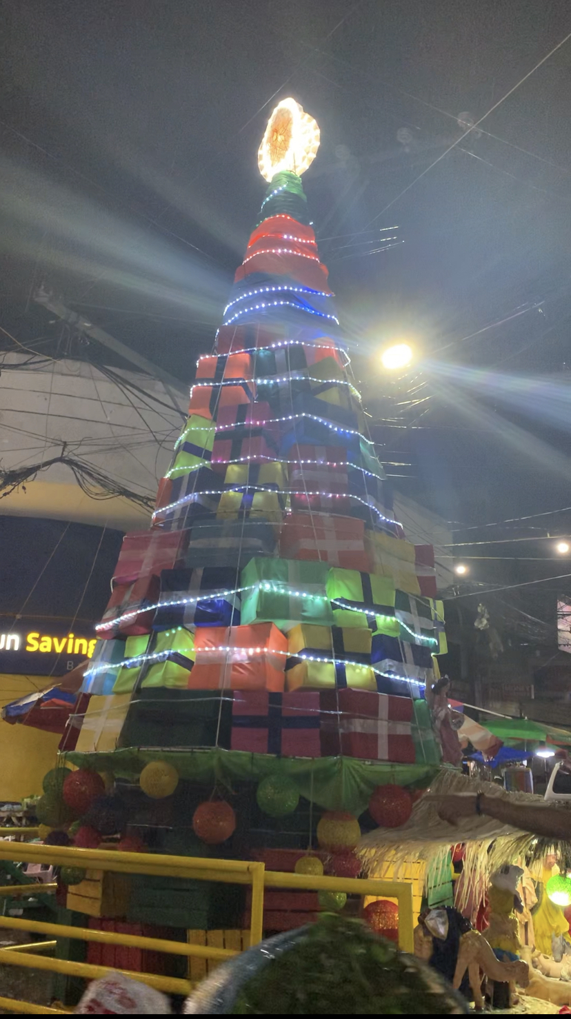 With the celebration of the Pasko sa Carbon, a giant Christmas tree made up of stacked-up gift boxes stands in the area. | Delta Dyrecka Letigio
