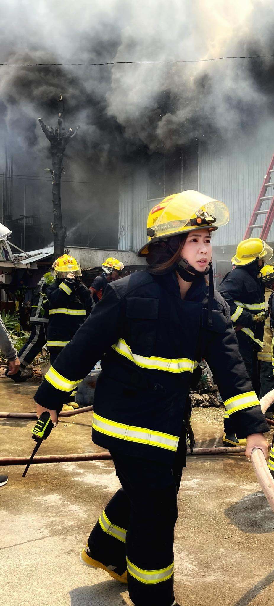 FO1 Novie Dagcuta, woman firefighter or one of the women firefighters of the CCFO. In photo is FO1 Novie Dagcuta responding with other CCFO firefighters to a fire in Cebu City.