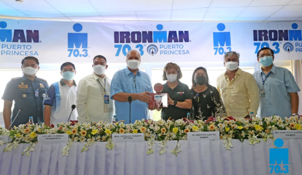 Princess Galura, the general manager of Ironman Philippines Group, and Puerto Princesa Mayor Lucilo Bayron hold the Ironman logo during the launching of the launching of the Ironman 70.3 Puerto Princesa. | Photo from Ironman 70.3 Puerto Princesa Facebook page.