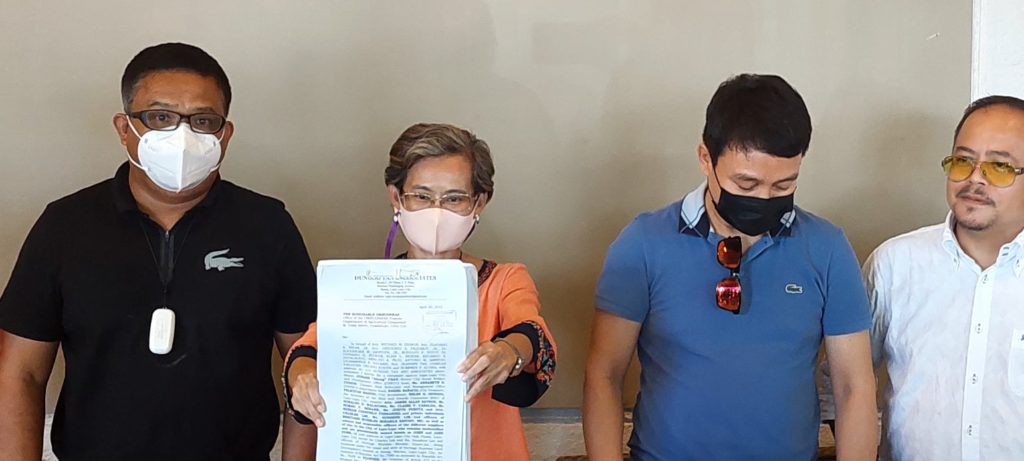 Lawyer Jennify Tan (second from left) shows the complaint against Mayor Junard Chan that she and Councilor Flaviano Hiyas  (third from left) and Charles Vailoces (right) filed at the Office of the Ombudsman Visayas today, April 25. They were accompanied by their lawyer, Ferdinand Dungog (left). | Futch Anthony Inso 