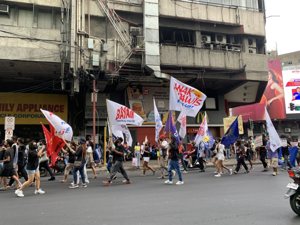 POLICE MONITOR PROTEST RALLY IN CEBU CITY TODAY. In photo are members of progressive groups holding a rally to protest the results of the May 9 elections. | Pegeen Maisie Sararaña