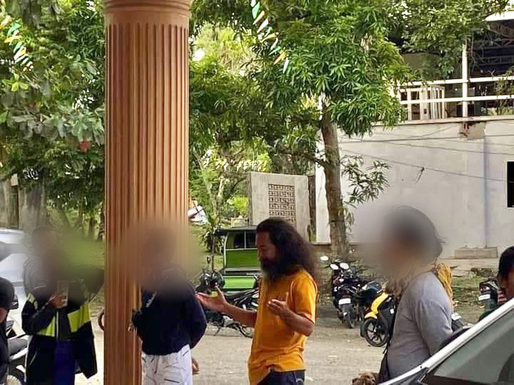 An alleged cult leader was arrested by Barili police outside the San Isidro Labrador Church on May 15 in Barangay Mantalongon, Barili town in southwestern Cebu after he led a group to allegedly disrupt a Holy Mass inside the church.. | Photo courtesy of Yenyen Pabroa via Paul Lauro