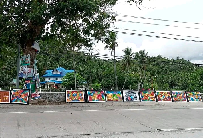 Artist Arnel Salvacion displays his paintings for sale by the roadsides in North Cebu.  |  Photo added