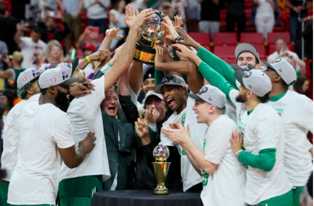 Al Horford #42 of the Boston Celtics celebrates with his teammates and the Eastern Conference Bob Cousy champions trophy after defeating the Miami Heat in Game Seven to win the 2022 NBA Playoffs Eastern Conference Finals at FTX Arena on May 29, 2022 in Miami, Florida. Andy Lyons/Getty Images/AFP