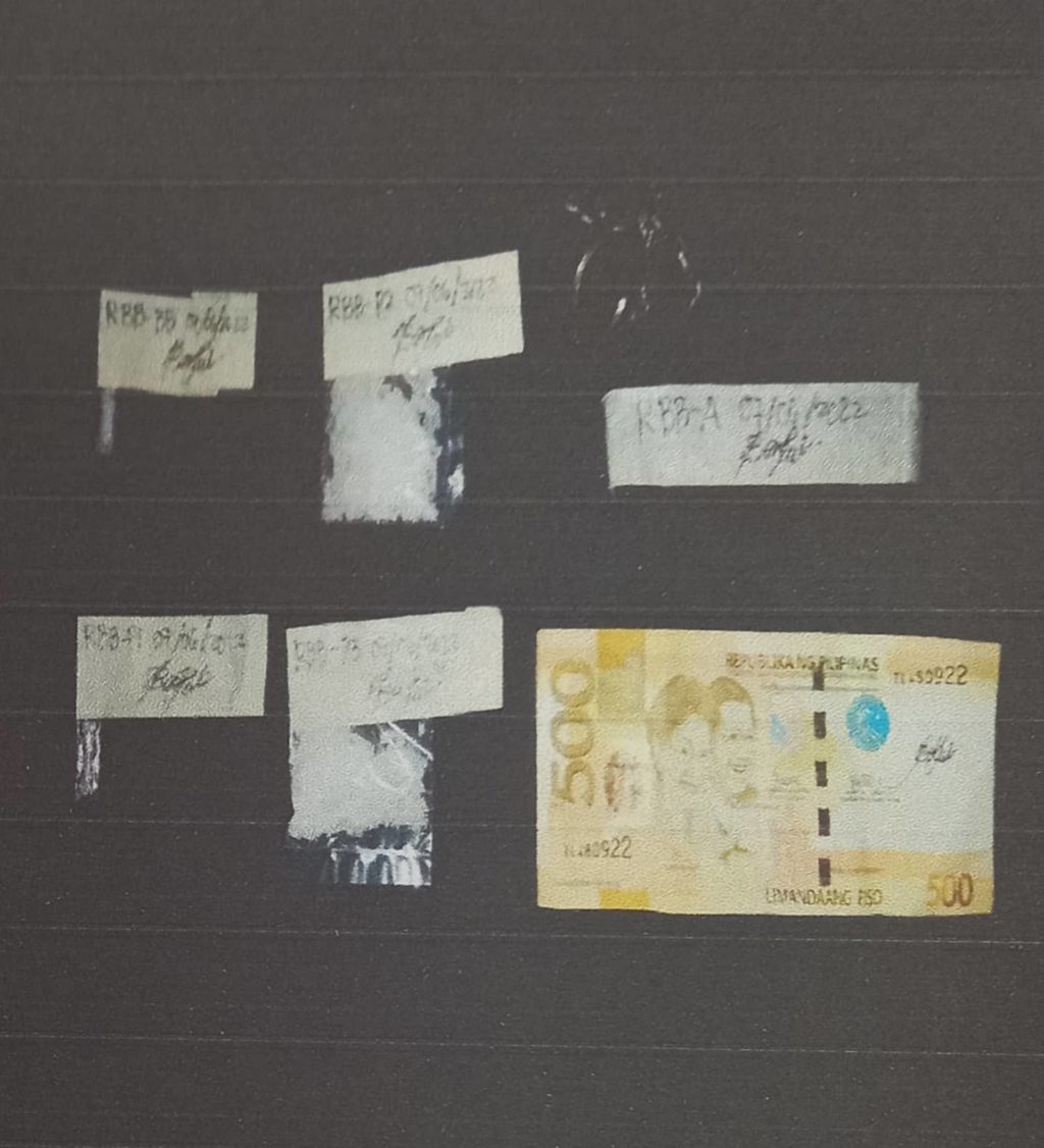 OPAO POLICE ARREST HVI. Ten grams of suspected shabu and cash are confiscated from Renante Bate during his arrest in a buy-bust operation in Barangay Umapad on July 6. | Contributed photo