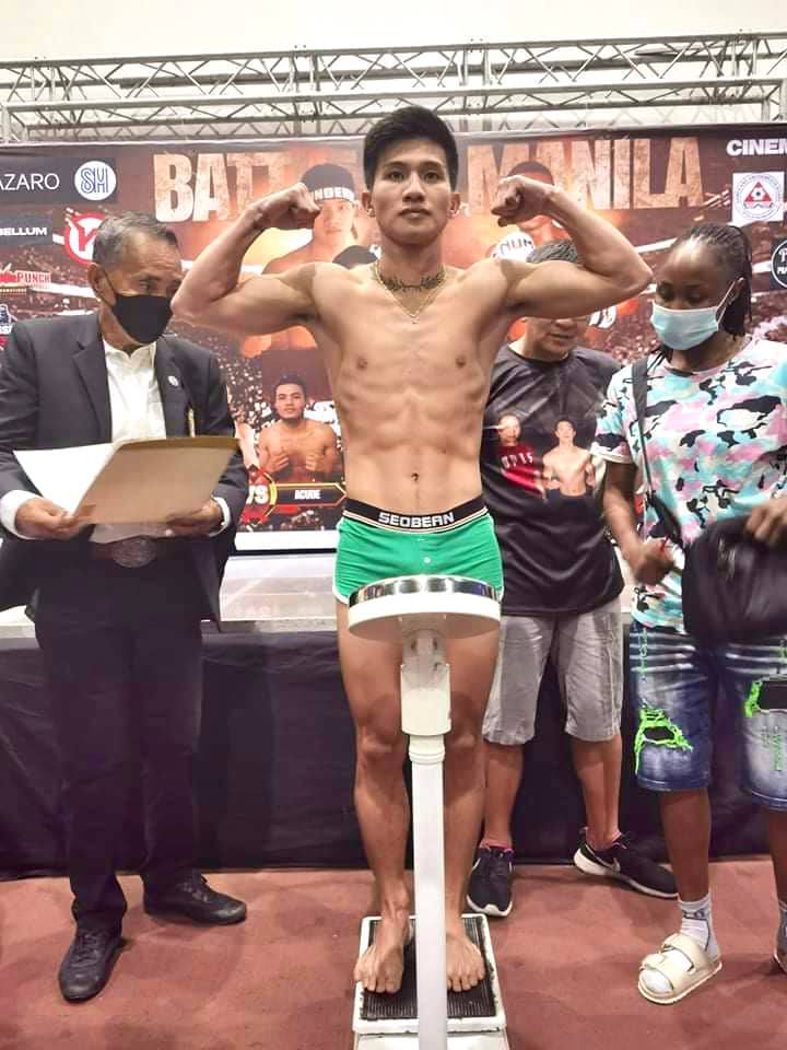 Carl Jammes Martin flexes his muscles during the weigh-in for his World Boxing Association (WBA) Asia super bantamweight title defense against Tanzanian Charles Tondo. | Photo from Martin's Official Facebook Page