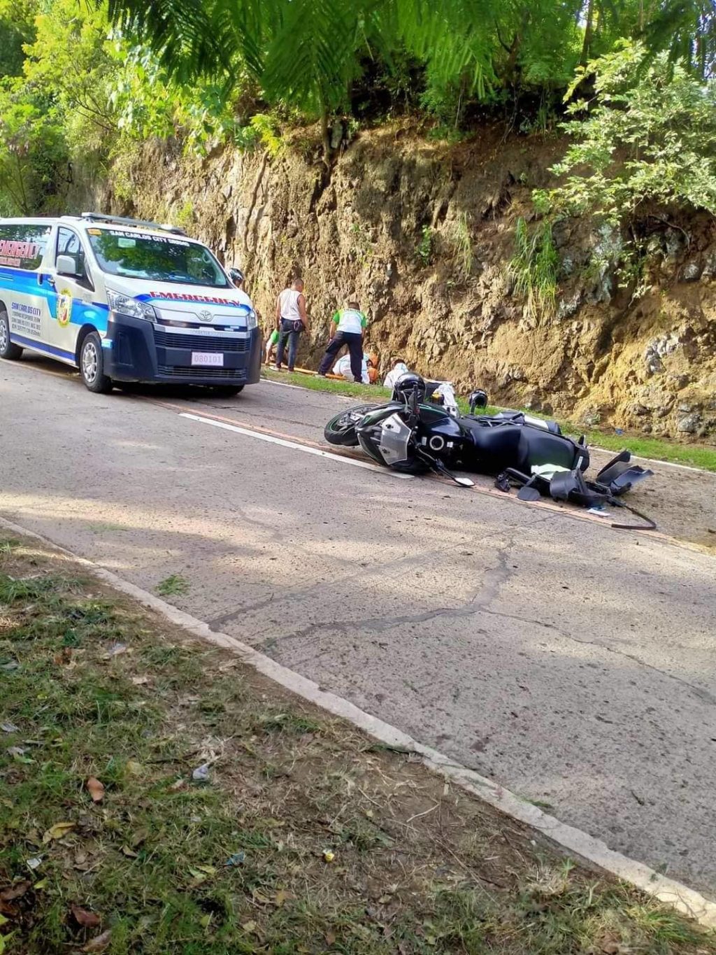 The motorcycle driven by Police Lieutenant Colonel Ruben Berbo, Guihulngan City Police chief, lies on its side after the road accident in San Carlos City in Negros Occidental. The police chief was killed in the accident. | Contributed photo via Paul Lauro