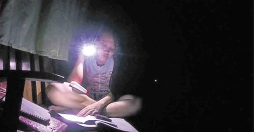 Photo of girl studying in the dark for story:NGCP: 15-hour total power interruption in Bohol on August 20