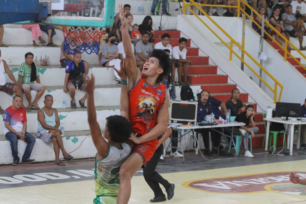 Bukidnon's Raul Gentallan soars high for a layup while being defended by a player from Asturias. | Photo from the PSL Media Bureau.