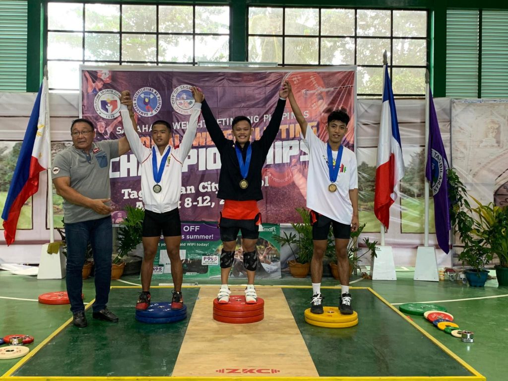 Fernando Agad (middle) also takes a gold medal for winning the men’s 55 Kg division with a total lift of 252 Kg at the Bohol weightlifting championships.| Photo from Ramon Solis of SWP