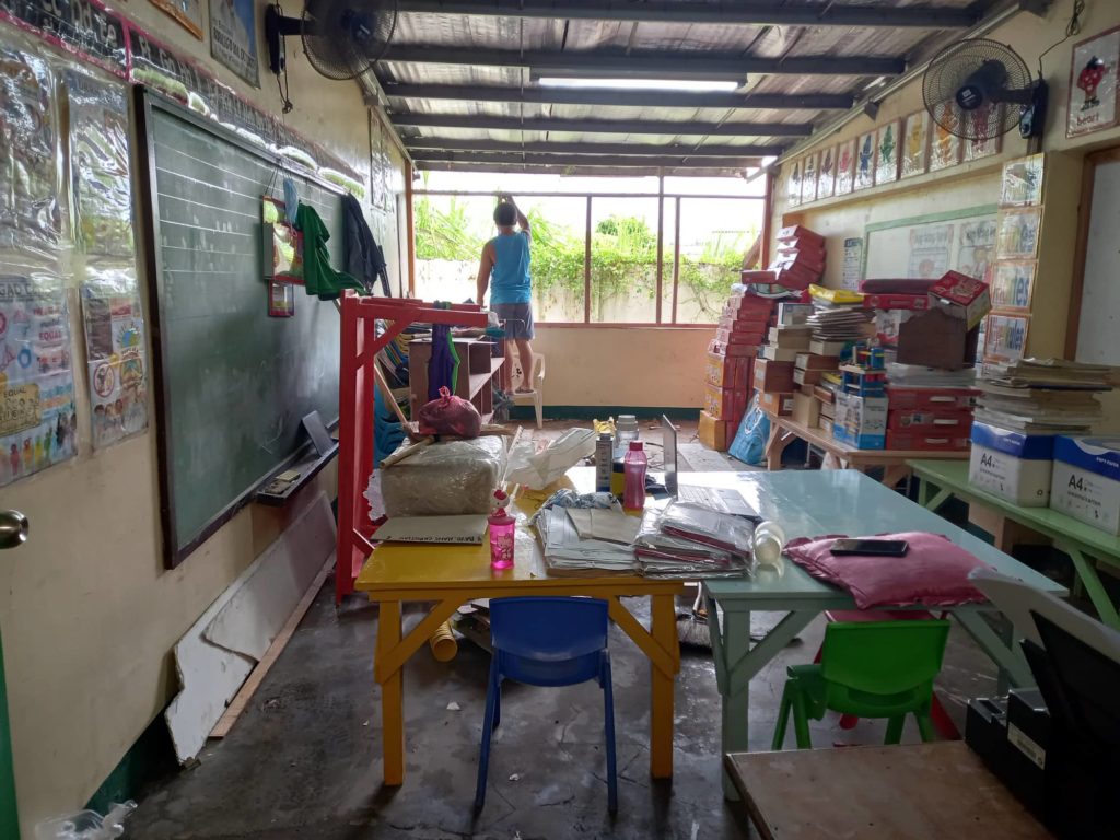 Teacher in Umapad: I let husband fix damaged classroom to save on cost. Cerelo Linao, husband of teacher Amelia Linao, repairs the kindergarten classroom of his wife, which is damaged by termites and typhoon Odette. | Mary Rose Sagarino