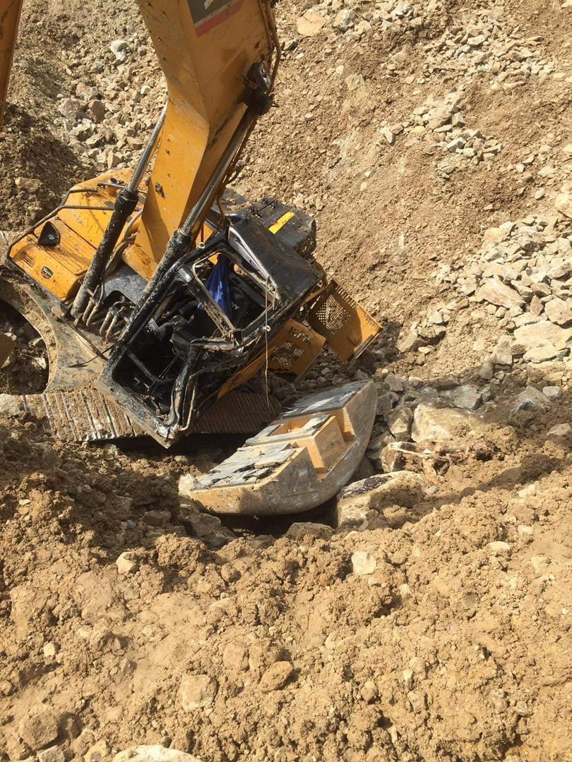 A construction worker was injured after the backhoe he was operating fell off a 60-foot cliff in Barangay Budlaan, Cebu City. | Budlaan Barangay Responder
