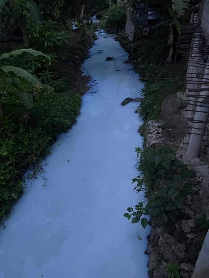 The water of a river in Borbon town turned white for two hours on Sunday, August 21, after a man washed a water flexible bag in the river. | 📷: Barangay Captain Margarito Ornopia Jr. via Futch Anthony Inso