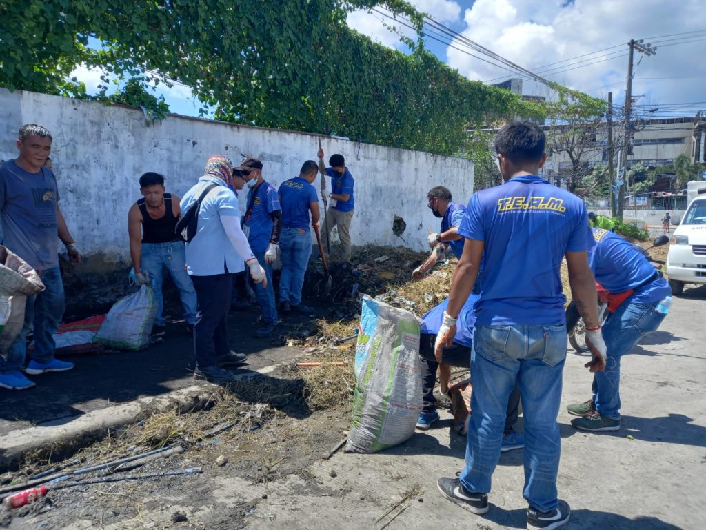 Personnel of the Mandaue City Enforcement Unit (MCEU) conduct a cleanup drive where they clean dirty sidewalks especially along A.S. Fortuna Extension in Barangay Guizo. | Mary Rose Sagarino