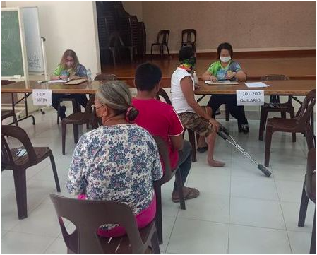 PWDs receive P2,000 aid. Persons with disability (PWDs) wait for their turn to receive the P2,000 cash aid from the Cebu City government in one of the distribution centers for the aid. | Cebu Environmental Sanitation and Enforcement Team (CESET) via Wenilyn B. Sabalo