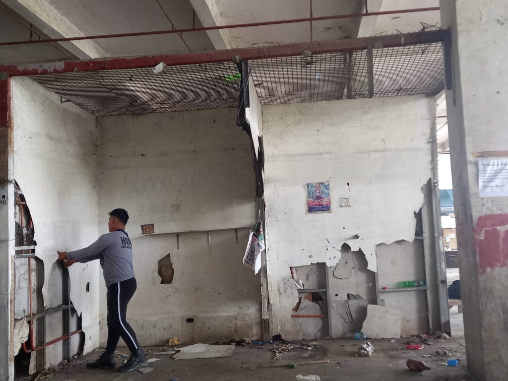 HUDO: 14 families taking shelter in old Mandaue public market sent home. Stalls of informal settlers inside the old Mandaue public market are taken down as those taking shelter in the building have been sent home to their respective barangays. | Mary Rose Sagarino