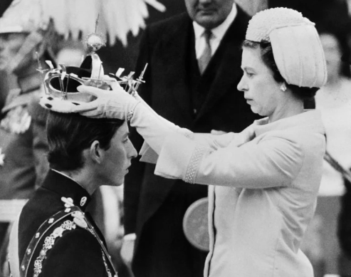 In this file photo taken on July 01, 1969 Queen Elizabeth II puts a crown on his son Prince Charles during his investiture as new Prince of Wales in Caernarfon. – Charles has spent virtually his entire life waiting to succeed his mother, Queen Elizabeth II, even as he took on more of her duties and responsibilities as she aged. But the late monarch’s eldest son, 73, made the most of his record-breaking time as the longest-serving heir to the throne by forging his own path. AFP FILE PHOTO