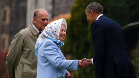 [FILE PHOTO] Britain's Queen Elizabeth II and her husband, Prince Philip, duke of Edinburgh, greet President Obama after he and his wife, Michelle, arrived by helicopter outside Windsor Castle, west of London, April 22, 2016. | JIM WATSON, AFP/GETTY IMAGES 