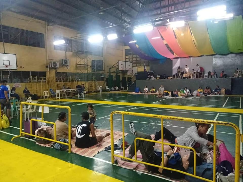 Stranded passengers occupy the tennis court of the Cebu City Sports Center.