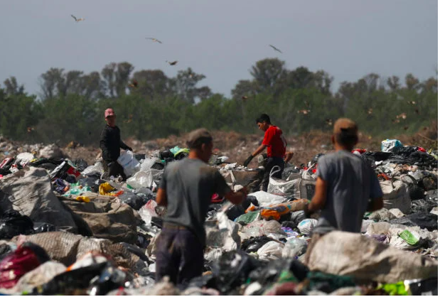 Waste recyclers look through heaps of waste at a landfill for cardboard, plastic and metal, which they sell while working 12-hour shifts, as Argentina faces one of the world’s highest inflation rates, set to top 100% this year, in Lujan, on the outskirts of Buenos Aires, Argentina October 5, 2022. REUTERS/Agustin Marcarian