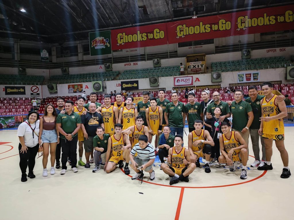 Jaguars escape tenacious Wildcats in Cesafi college hoops game. The USJ-R Jaguars team officials and players pose at center court after beating CIT-U Wildcats in the Cesafi men's basketball on Sunday evening, Nov. 6, 2022. | Glendale Rosal