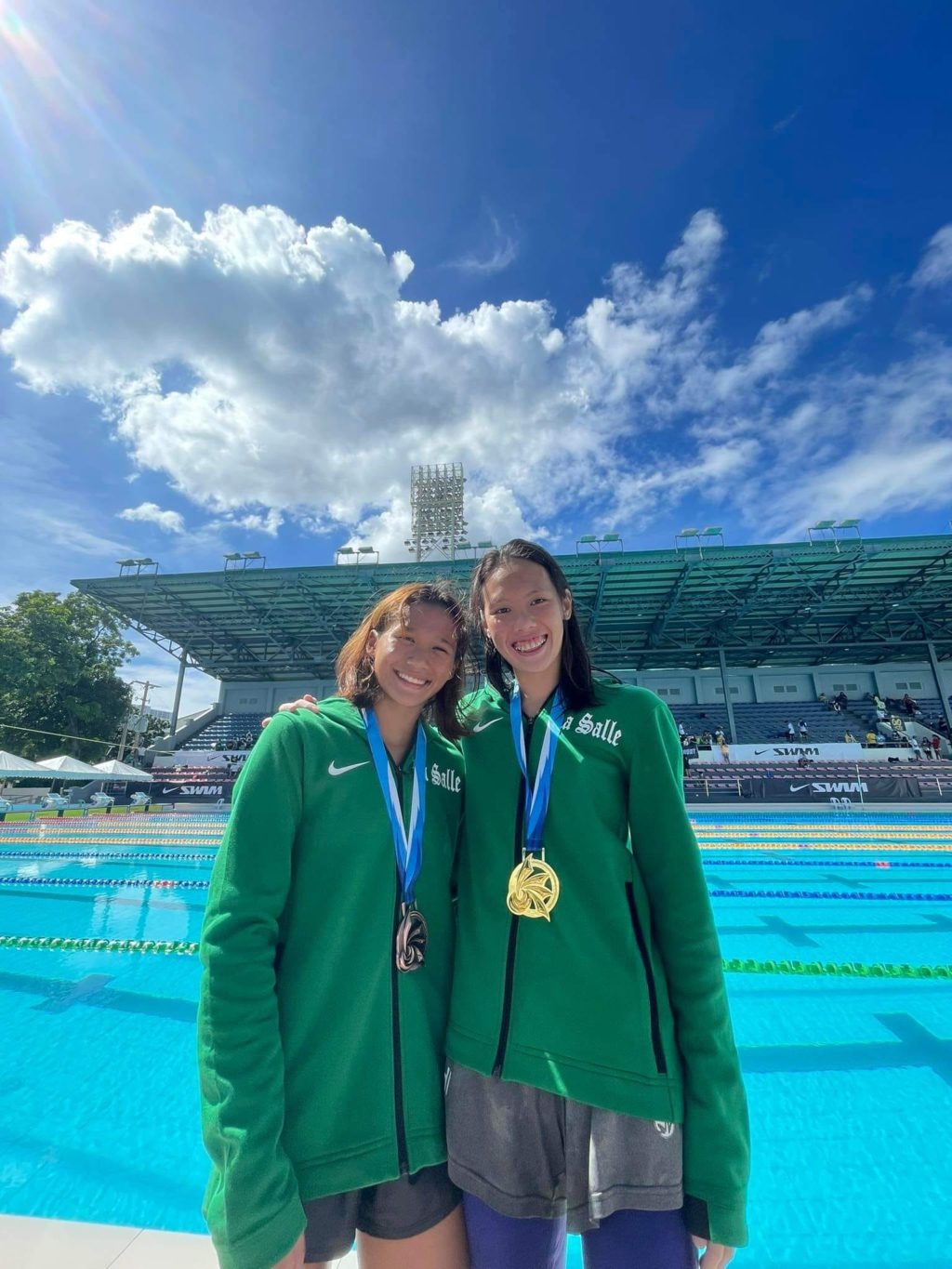 Cebuana triathlete, Alcoseba, wins 400-m freestyle silver, increases her UAAP medal haul to 3. Raven Faith Alcoseba (left) poses with her teammate Xiandi Chua (right) during the UAAP swimming competition in Manila. | Photo from Fritz Alcoseba