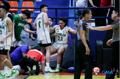 St. Benilde Blazers’ Taine Davis staggers after taking a punch from John Amores. NCAA PHOTO