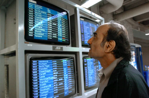 Iranian exile who inspired the movie ‘The Terminal’ dies at French airport. Mehran Karimi Nasseri checks the monitors 12 August 2004 in the terminal one of Paris Charles De Gaulle airport. AFP FILE PHOTO